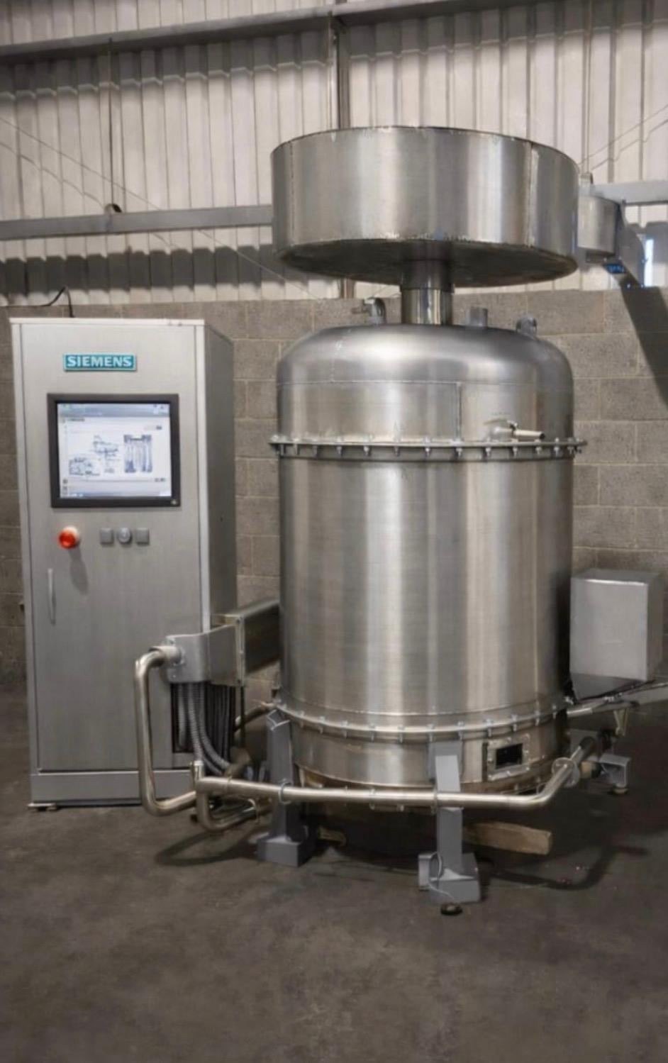 The Cyclonox stainless steel unit and its Siemens control cabinet installed in a warehouse.