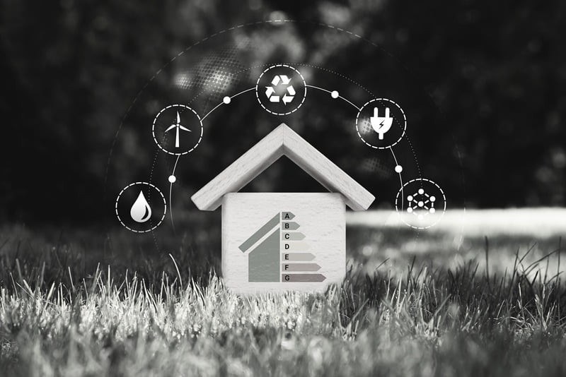 Black and white concept image of a house with energy symbols overlaid.