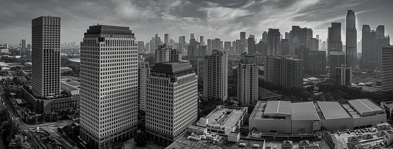Black and white panorama of a city skyline of high-rise towers.
